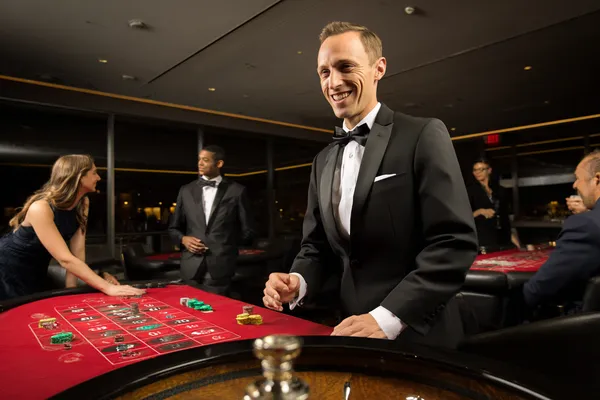 A woman smiling by bright slot machines showing lucky symbols, showcasing the exciting slot offerings at KK3333.